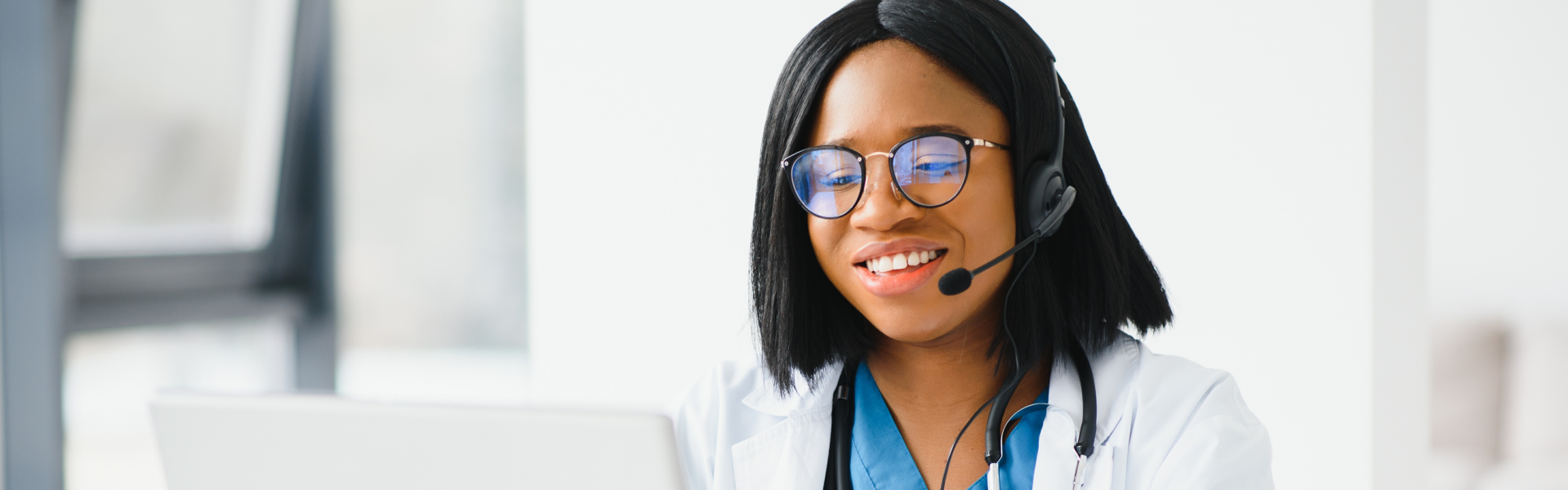 A female doctor wearing headphone talking to her client through a call